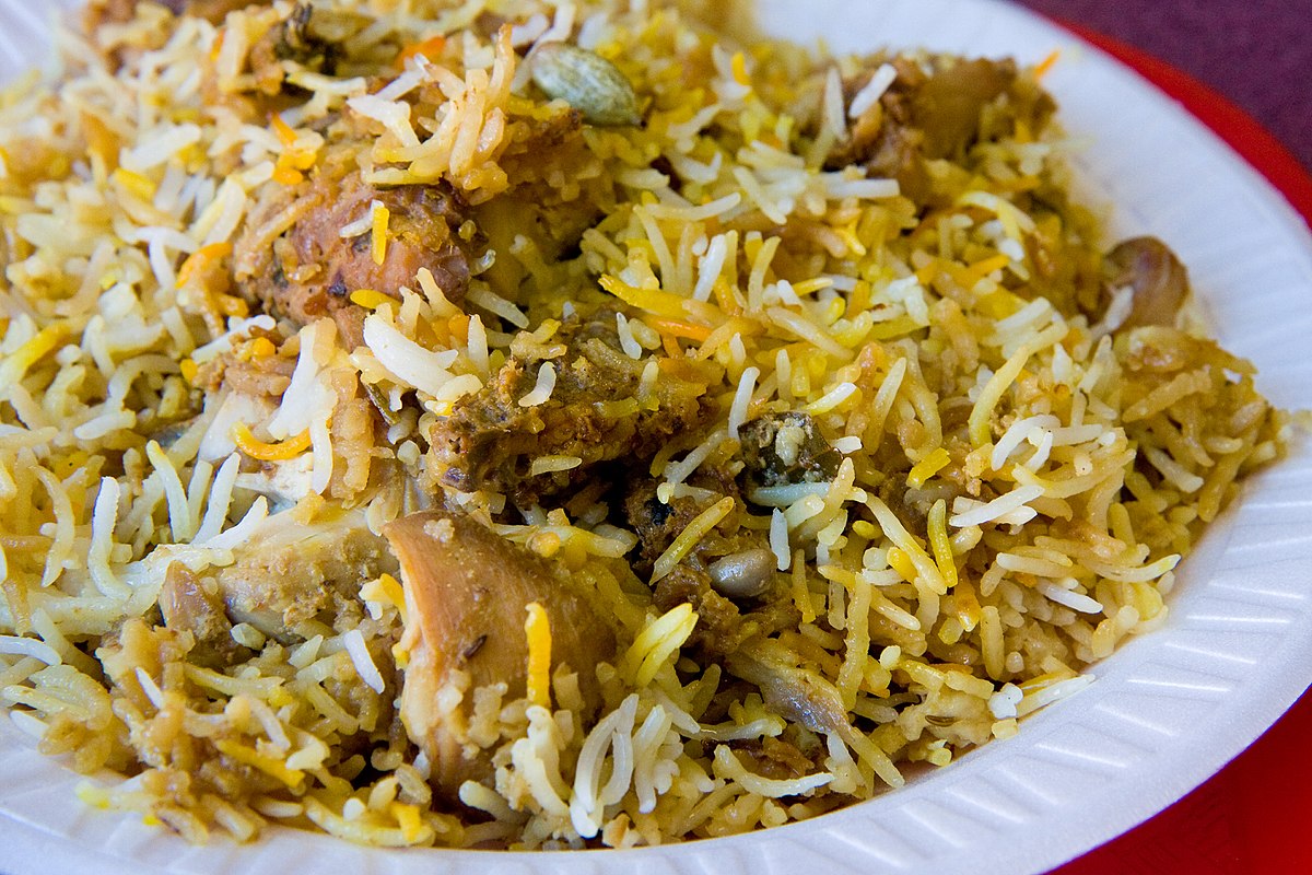 A serving of rich, saffron-infused Biryani on a wooden platter 